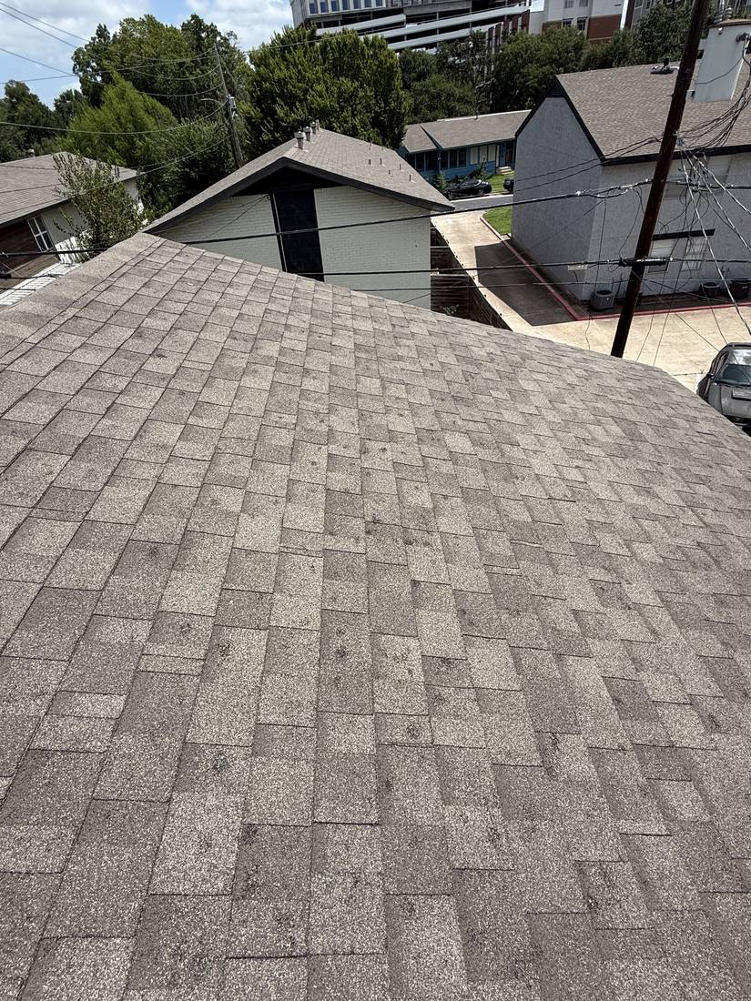 Asphalt shingle roof being inspected for storm damage